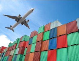 A plan flies over shipping containers.