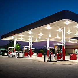 Photograph of a gas station at night.