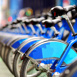 Photograph of a row of city bikes for rent at docking stations.