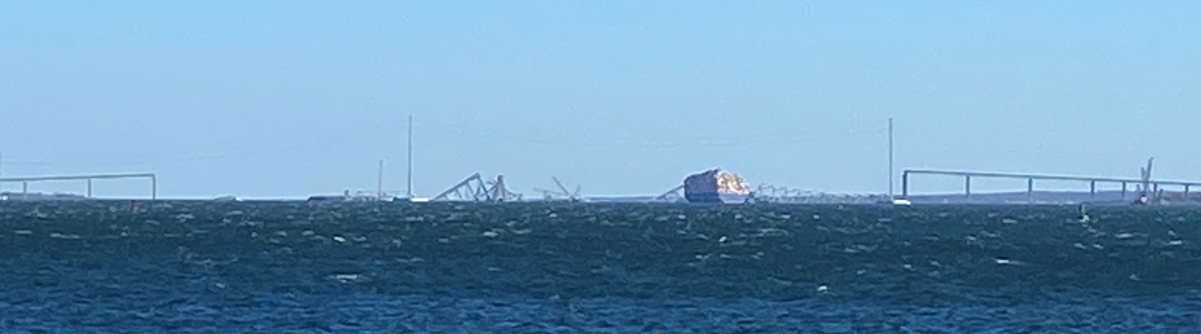 Remains of Francis Scott Key Bridge with container ship Dali, taken from Fort McHenry on March 30, 2024. (Source: Rolf Schmitt)