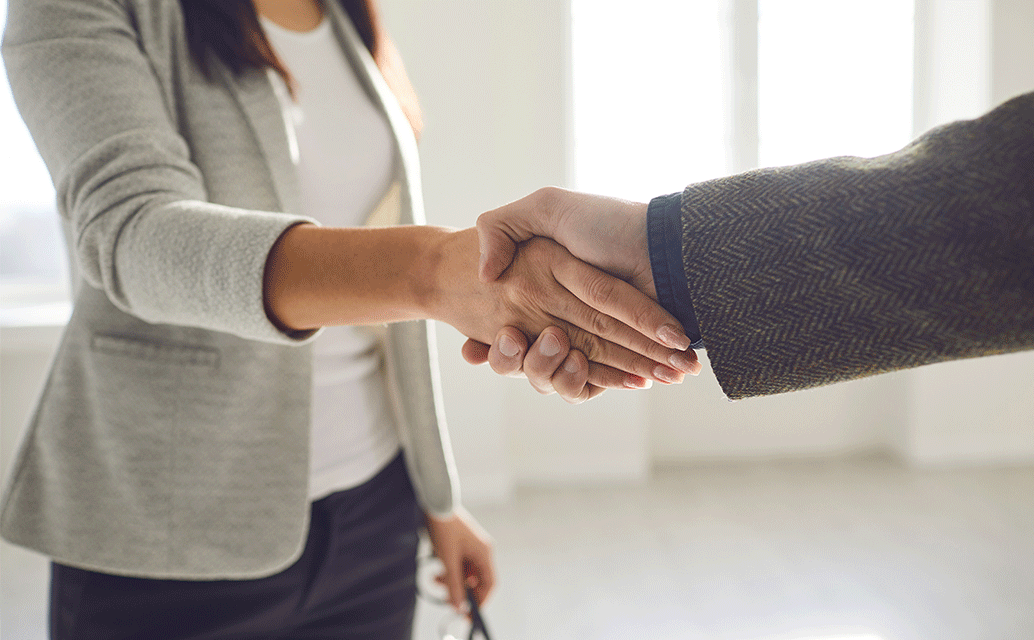 Image of two people shaking hands.