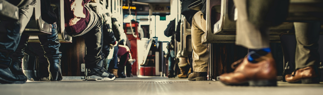 "Ground view of seated public transit passengers"